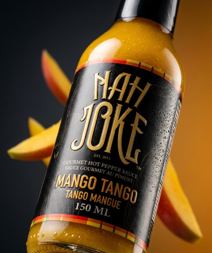 NAH JOKE Mango Tango hot pepper sauce bottle with fresh mango slices